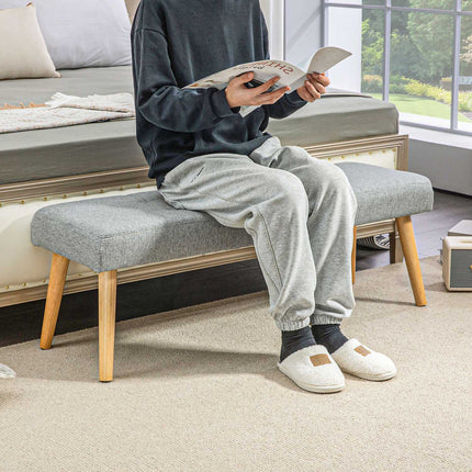Gray upholstered bench with button seams, 120x41x43 cm