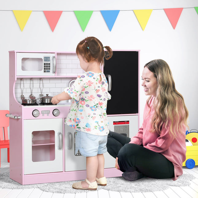 Pink play kitchen for children with toy phone and accessories