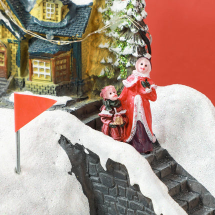 Christmas village with LED lights, music and moving train