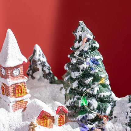 Christmas village with LED lights and moving train