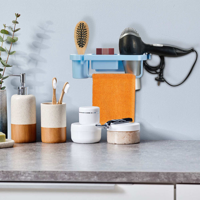 Hair dryer holder for the wall