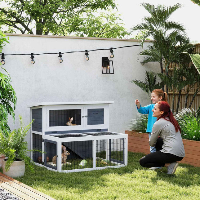 Two-story rabbit hutch with outdoor enclosure