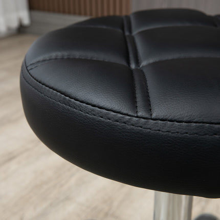Height-adjustable salon stool in black artificial leather
