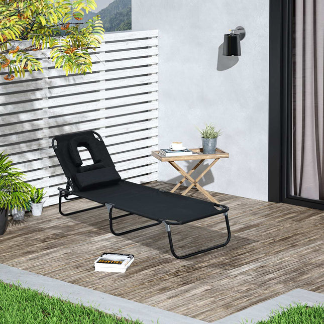 Black sun lounger with face opening for relaxation