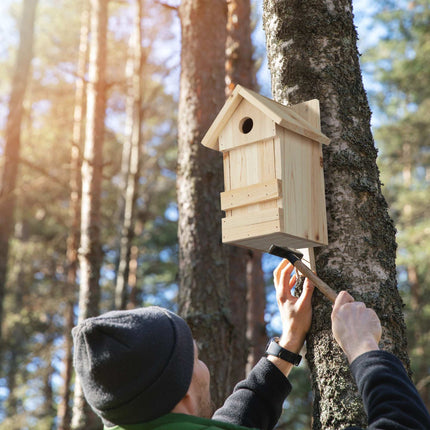 Wooden birdhouse with pointed roof