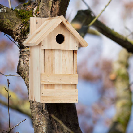 Wooden birdhouse with pointed roof